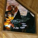 Big Buck Trapezoid Window - An interior window is the showpiece in the loft of a lovely Wisconsin Country Home.  The big buck deer is the center of attraction and showing off his beauty among all his favorite surroundings of pine trees, a trickling stream with flat rocks, and wild flowers.